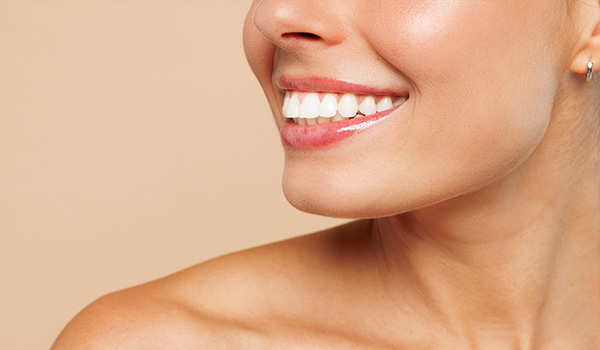 smiling woman with flawless skin showing bright white teeth highlighting beauty secrets for achieving the perfect smile and confidence 9 tips for dental care